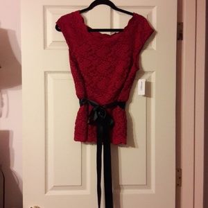 Red lace blouse with black satin bow